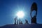 Silhouettes of children playing and riding on a snow slide, copy space