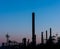 Silhouettes of chimneys, pipes and other equipment at an oil refinery