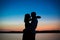 Silhouettes of a couple in love romance at sunset