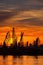 Silhouettes of cranes and cargo ships in port