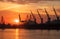 Silhouettes of cranes and cargo ships in Varna