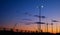 Silhouettes of cranes in the harbor at sunset