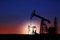 Silhouettes of crude oil pumps. Space for text