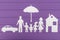 The silhouettes cut out of paper of man and woman with two girls and boy under the umbrella, house and car near