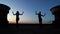 Silhouettes of dancing duo on roof at night