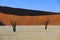 Silhouettes of dry hundred years old trees in the desert among red sand dunes. Unusual surreal alien landscape with dead