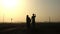 Silhouettes of Egyptian couples are on the road holding hand at sunset