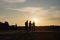 Silhouettes of engineers at construction site at sunset. Generative AI