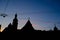 Silhouettes of evening Lviv. View on Hlyniany Gate and Bernardine church. Ancient city walls