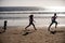 Silhouettes of family jogging along sea beach at sunrise. Outdoor workout, silhouettes of runners, sport and healthy