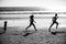 Silhouettes of family jogging along sea beach at sunrise. Outdoor workout, silhouettes of runners, sport and healthy