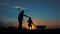 Silhouettes of father and daughter going with transportation for the land and a rake tool. Small scale organic farming
