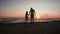 Silhouettes father and daughter play on the beach at sunset. Concept of friendly family, travel, lifestyle.