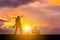 Silhouettes of father and daughter playing at sunset evening sky background