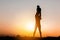 Silhouettes of father and daughter playing at sunset evening sky background