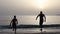 Silhouettes of father man boy sun diving sousing at sunset sea