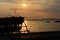 Silhouettes fishing boats at sea in sunset.