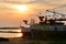 Silhouettes fishing boats at sea in sunset.