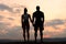 Silhouettes of a fitness couple watching the sunrise. Beauty and perfection of human\'s body
