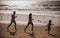 Silhouettes of fitness family running near sea.