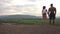 Silhouettes of a fitness muscular mixed race couple watching the sunrise together. Beauty and perfection of human\'s body