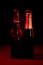 Silhouettes of four beer bottles on a black background and lit with red light