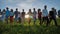 Silhouettes friends holding hands on a sunset background.