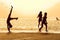 Silhouettes of girls on the beach at sunset