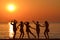 Silhouettes of girls dancing at the sunrise