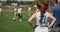 Silhouettes of girls from the female flag football team watching the game. Team strategy during the match at the stadium