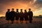 Silhouettes of graduates on the background of the sunset. Graduation concept, rear perspective of a group of university graduates