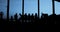 Silhouettes - Group of people is sitting together at evening light - camera zoom in - slow motion