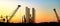 Silhouettes of harbor cranes in the port of Valletta city against the evening sky