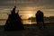 Silhouettes of a hugged couple with a big bonfire in the beach