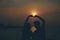 Silhouettes of hugging couple against the sea at sunset.