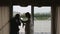 Silhouettes just married couple near big window in rainy day