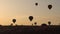 Silhouettes Lots of hot air balloons flying over valleys in Goreme, Turkey. Tourists from all over the world come to