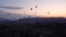 Silhouettes Lots of hot air balloons flying over valleys in Goreme, Turkey. Tourists from all over the world come to