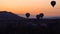 Silhouettes Lots of hot air balloons flying over valleys in Goreme, Turkey. Tourists from all over the world come to