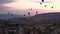 Silhouettes Lots of hot air balloons flying over valleys in Goreme, Turkey. Tourists from all over the world come to