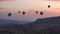 Silhouettes Lots of hot air balloons flying over valleys in Goreme, Turkey. Tourists from all over the world come to