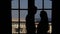 Silhouettes loving couple kissing, background doors, balcony with a sea view