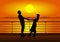 Silhouettes of man and woman on deck of ship