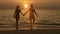 Silhouettes of the man and woman, leaving the sea at sunset