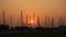 Silhouettes of masts of ships in the bay at sunset. Ha Long Bay. Vietnam.