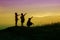 Silhouettes of mather and little daughter walking at sunset