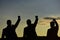 Silhouettes of men putting their fists up. Figures expressing confidence