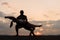 Silhouettes of mixed gymnastic couple dancing on sunset. Grace and beauty of human\'s body