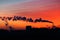 Silhouettes of modern buildings, architecture and smoke from the chimneys