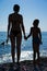 Silhouettes of mother and daughter on beach